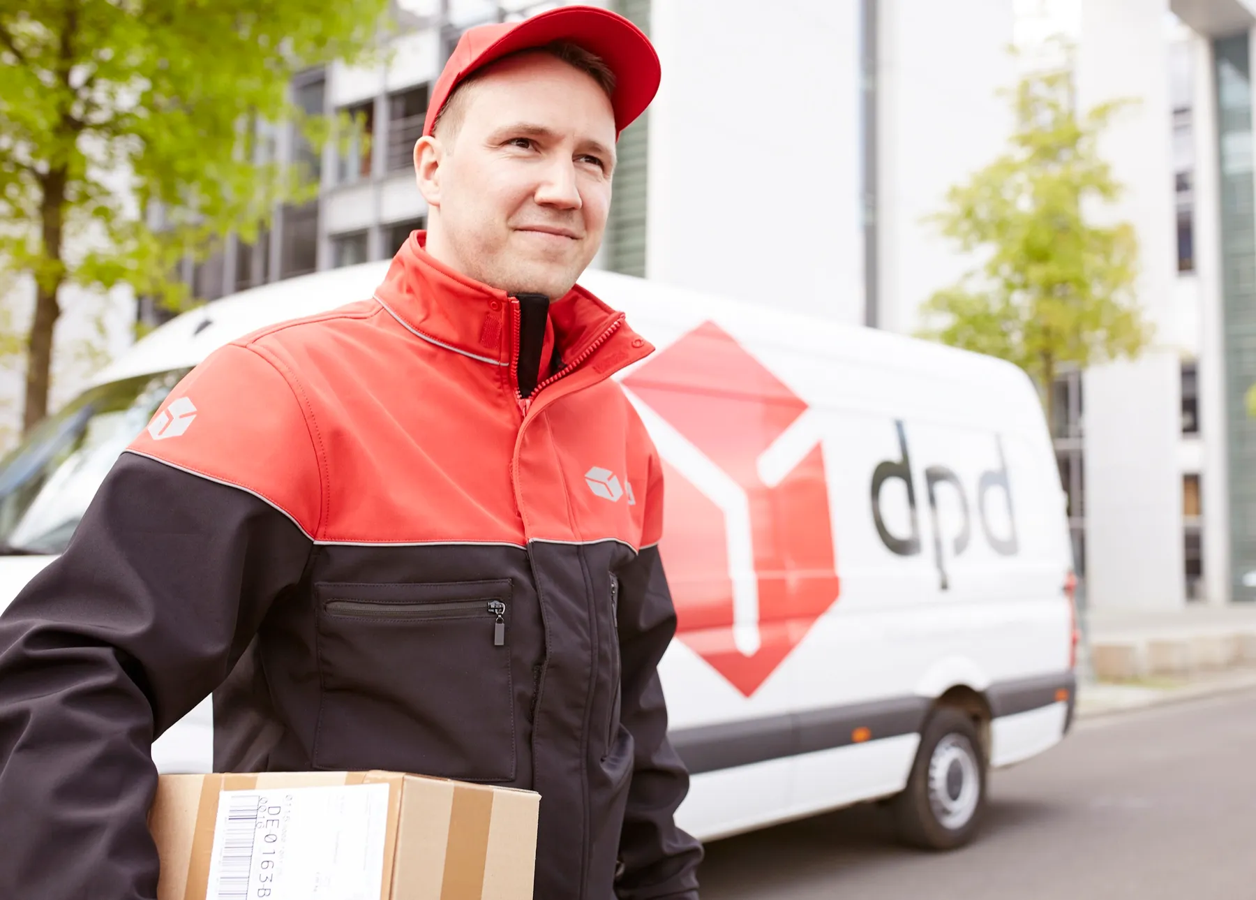 Porträt des dpd-Zustellers neben dem roten Lieferwagen